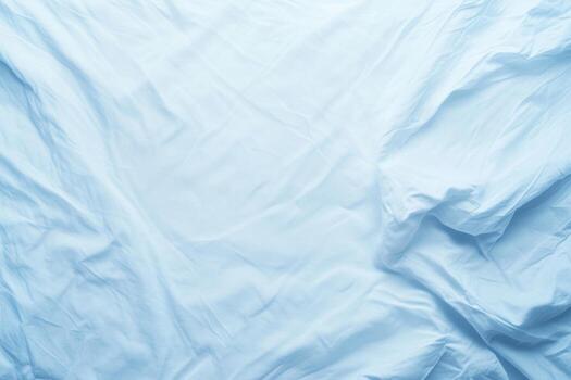 Bright blue wrinkled fabric draped on a surface creating a soft texture photo