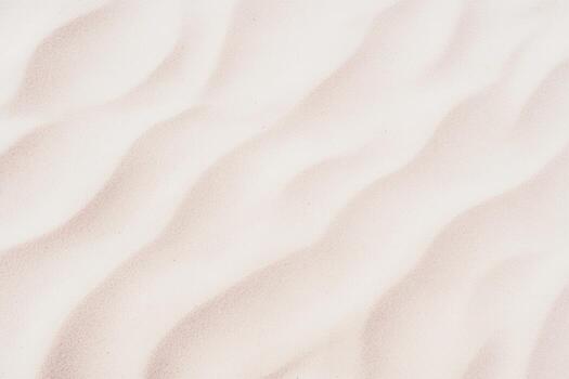 Patterns in soft sand create a serene landscape at the beach during daytime photo