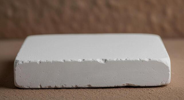 Close-up of a white rectangular block against a blurred background. photo