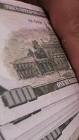 ein Person halten ein Stapel von Rechnungen mit ein Dollar Zeichen video
