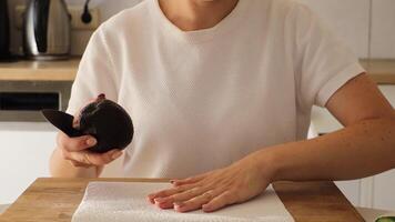In this close-up, a woman skillfully prepares sushi at home, focusing on slicing an avocado and assembling fresh ingredients for a delicious meal that anyone can recreate video