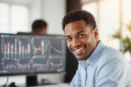 Happy businessman against white screen background with desktop computer charts in office. photo