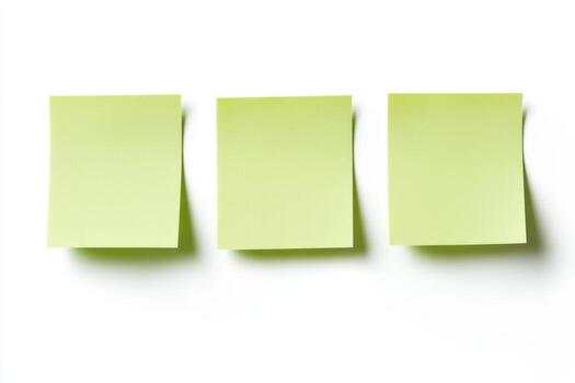 Three green sticky notes on a white surface photo