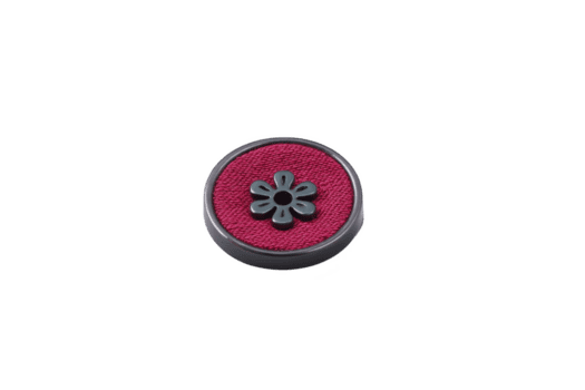 Round, decorative button with red fabric center and floral design in middle, set against transparency background. button intricate pattern adds touch of elegance png