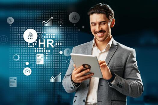 Business professional engaged in HR tasks using a tablet with digital graphics in the background at a modern office space photo