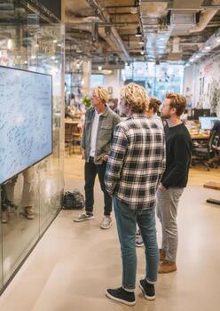 Startup businesspeople brainstorming and discussing notes on monitor in office photo