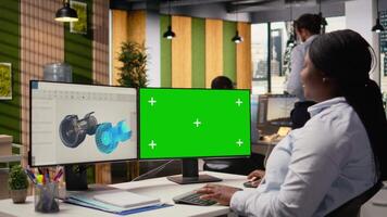 Engineer using CAD app on green screen mockup computer to reduce carbon footprint of wind turbines. RD office professional upgrading eco friendly windmill parts on chroma key PC, camera A video