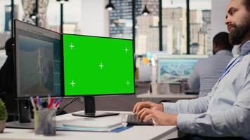 Engineer working on futuristic wind turbine concept on green screen PC designed for clean energy output. Man in office uses mockup computer to research cutting edge VAWT innovation, camera B video