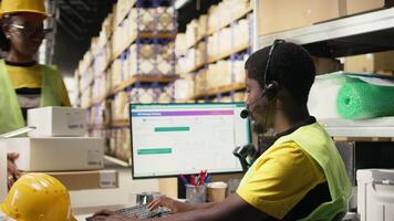 Customer support employee assisting clients in an industrial logistics hub, handling order mix up on e-commerce help line service. Black man resolving issues related to delivery delays. Camera A. video