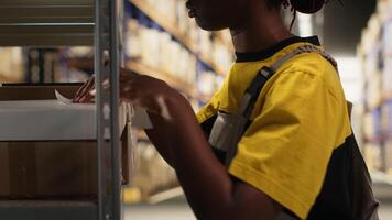 lager kontorist placering lim frakt etiketter på lådor i lagring rum depå, märkning paket med awb spårning tal till säkerställa sömlös uttrycka leverans och beställa bearbetning. kamera b. video