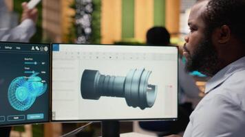 Wind energy researcher analyzes turbine component to maximize sustainability. CAD designer in office uses digital modeling software to refine blade aerodynamics, boosting clean energy output, camera B video