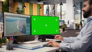 Engineer working on futuristic wind turbine concept on green screen PC designed for clean energy output. Man in office uses mockup computer to research cutting edge VAWT innovation, camera A video