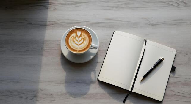Minimalist writer's desk with coffee and open notebook. Top view flat lay of a creative workspace with natural light, perfect for concepts of journaling, studying, or a peaceful morning routine. photo