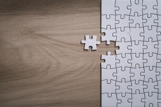 White Jigsaw Puzzle Pieces on Wooden Table, Almost Complete, Representing Connection and Problem Solving photo