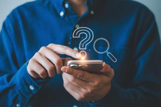 Person using smartphone to search for answers, seeking information and solutions with question mark and magnifying glass icons on screen, problem-solving concept photo