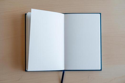 Blank notebook with open pages on wooden desk, ready for ideas and notes, representing new beginnings and potential photo