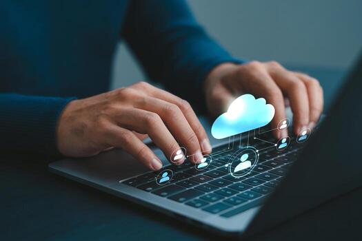 Person using laptop computer to access cloud computing network of digital profiles, working remotely from home office at night photo