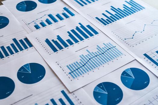 Detailed financial reports and business analytics charts spread on a table, showing growth and progress in a modern office setting This image conveys the concept of business succes photo