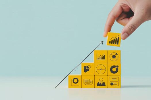 Hand placing growth chart block on yellow business strategy blocks, representing growth, planning, and progress towards goals Concept of building success and achieving mi photo