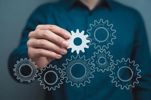 Person connecting gears mechanism, a process of teamwork and collaboration, in a modern business setting, symbolizing efficiency and strategic planning photo