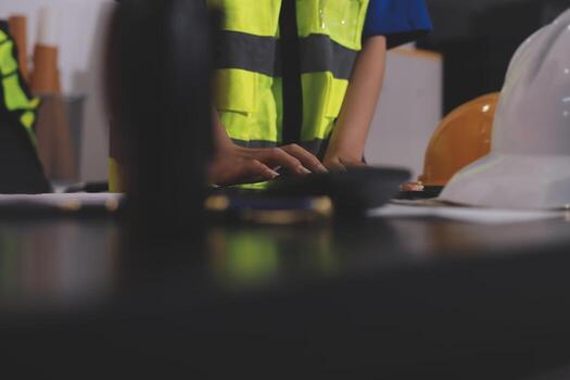 A person in a safety vest working on a computer photo