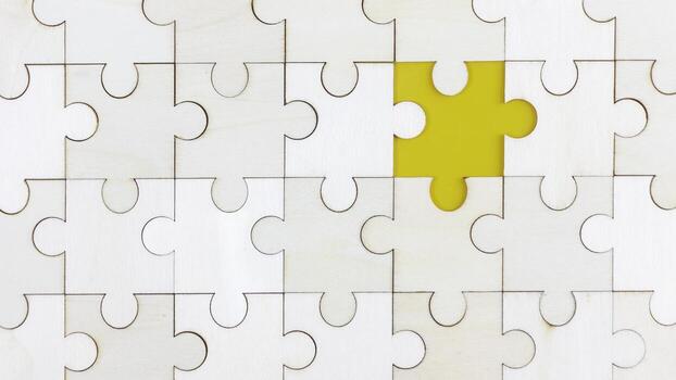 White puzzle on yellow background with empty space. Business strategy teamwork or problem solving concept. photo