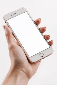 Hand holding a smartphone with a blank screen ideal for displaying apps or messages in a minimalist setting photo