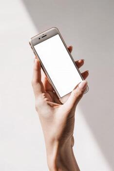 A person holding a cell phone with a blank screen photo