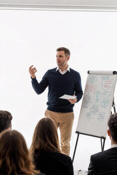 A man giving a presentation to a group of people photo