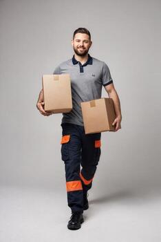 Delivery worker carrying boxes while walking indoors with a cheerful expression in a modern setting photo