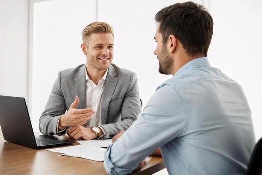 Two professionals engage in a discussion during a business meeting in a modern office environment photo