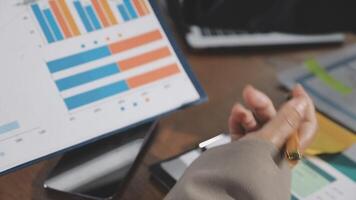 A person is pointing at a chart on a computer screen video