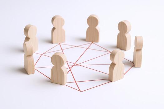 Wooden Figures Connecting Concept for Teamwork, Networking, Communication, and Interpersonal Relationships on a White Background photo
