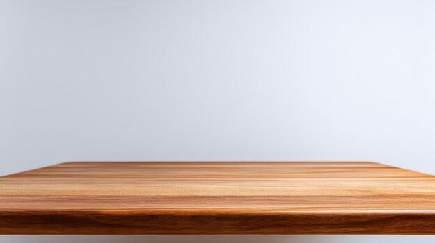 Wooden Tabletop Surface Against a Gray Wall Background, Ideal for Product Mockups and Presentations photo