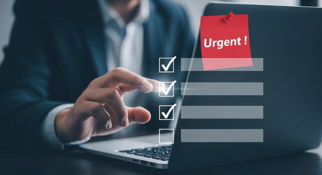 Businessman Reviewing Urgent Checklist on Laptop, Ensuring Task Completion and Meeting Deadlines Effectively photo