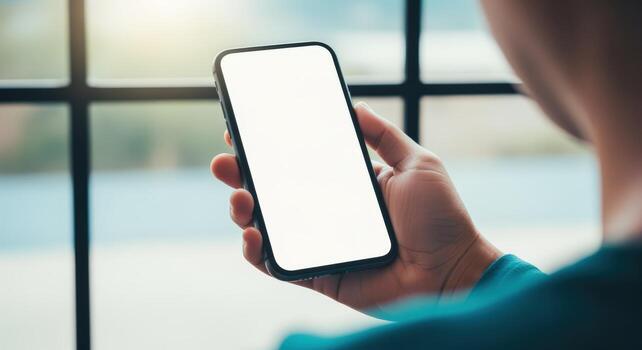 Person Holding Smartphone with Blank White Screen for App or Website Promotion, Mobile Mockup photo