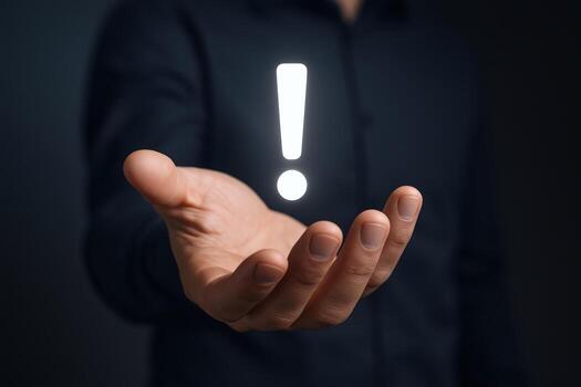 Exclamation Point Hovering Above Palm of Hand Symbolizing Important Notification, Caution, or Alert photo