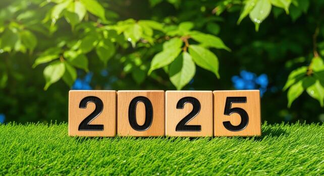 Year 2025 on Wooden Blocks with Lush Greenery Background, Symbolizing Future Growth and New Beginnings photo