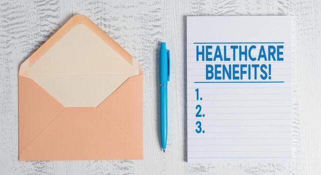 Healthcare Benefits Communication Open Envelope, Pen, and Notepad Listing Advantages on a Light Wooden Surface photo