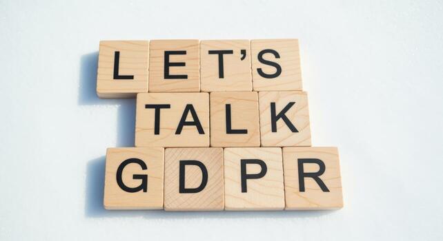GDPR Compliance Concept with Wooden Blocks Spelling Lets Talk GDPR on White Background photo