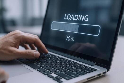 Laptop Loading Screen with Progress Bar Showing Data Transfer and a Hand Typing photo