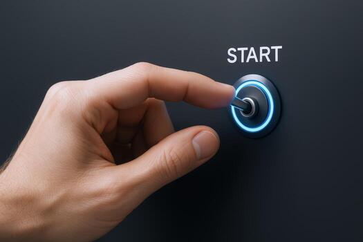 Finger Activating a Start Button with a Blue Light Ring on a Dark Surface photo