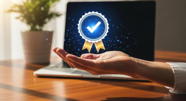 Quality Assurance Concept Hand Presenting a Digital Badge on Laptop Display for Business Excellence photo