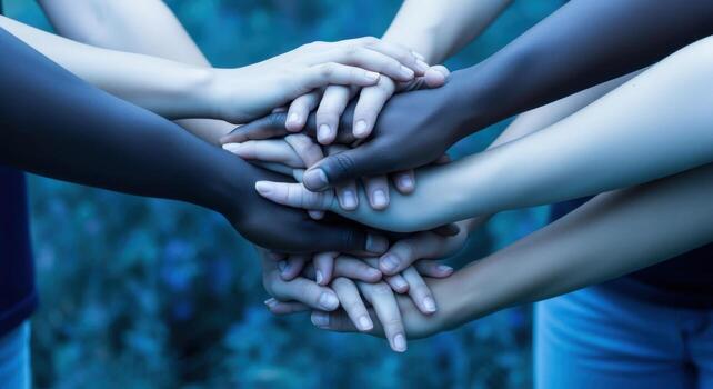 Diverse hands joined together representing collaboration, unity, teamwork, support, diversity, partnership and community, symbolizing a sense of togetherness photo