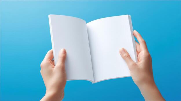 Person Holding Open Book with Blank Pages on Blue Background for Mockup or Advertisement photo
