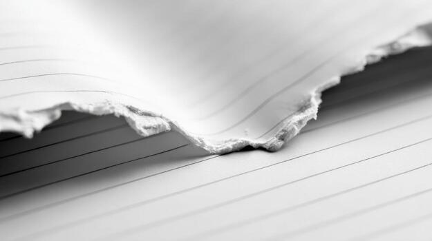 Torn Notebook Paper Close-Up Blank Sheet with Ripped Edge for Creative Concepts and Backgrounds photo