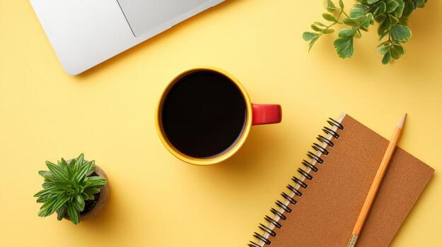 Workspace Flat Lay with Coffee, Notebook, Laptop, and Plant on Yellow Background for Blog and Office photo