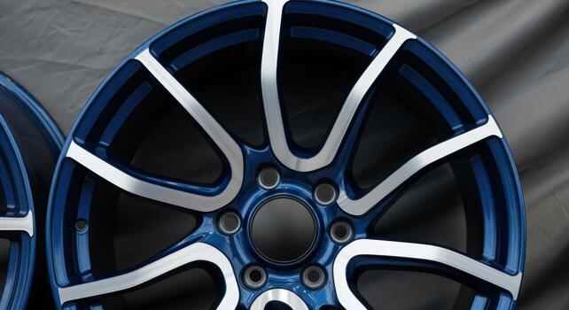 Close-Up of a Blue and Silver Alloy Wheel Displaying Automotive Engineering and Design photo