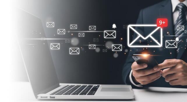 Businessman Checking Email Notifications on Phone with Laptop, Digital Communication and Marketing Strategy photo