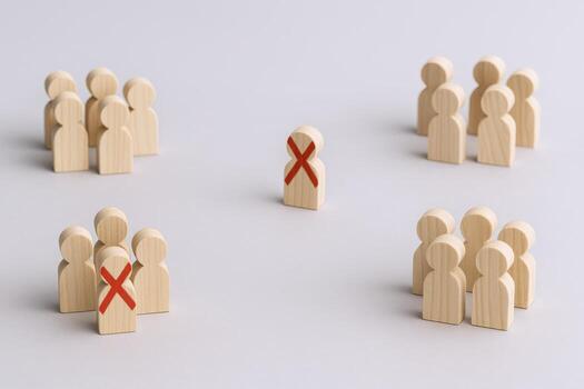 Wooden Figures Depicting Segregation, Exclusion, Rejection, and Social Distancing, Concept for Discrimination, Bias, Prejudice, and Inequality photo